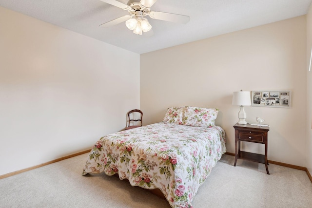 carpeted bedroom featuring a ceiling fan and baseboards