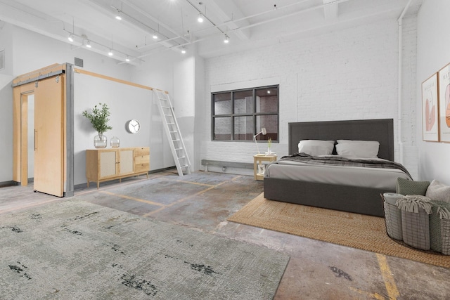 bedroom featuring brick wall, a high ceiling, concrete floors, and visible vents