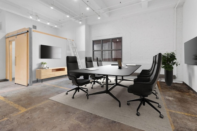 home office with brick wall, a high ceiling, visible vents, rail lighting, and unfinished concrete floors