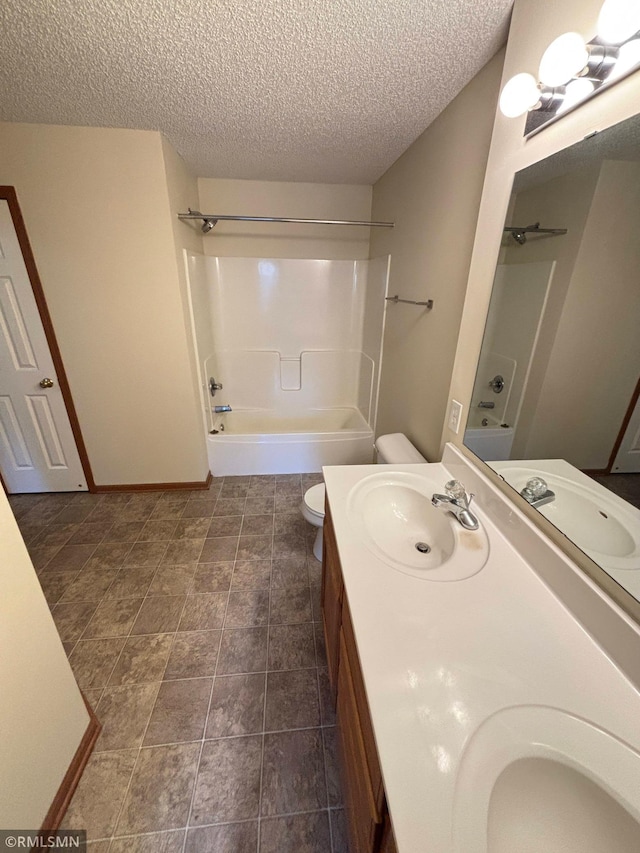 full bath with toilet, double vanity, a sink, and shower / bathing tub combination