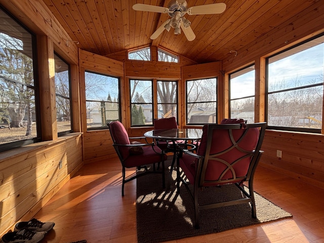 sunroom / solarium with plenty of natural light, wood ceiling, ceiling fan, and vaulted ceiling