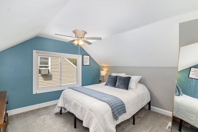 carpeted bedroom featuring a ceiling fan, vaulted ceiling, and baseboards