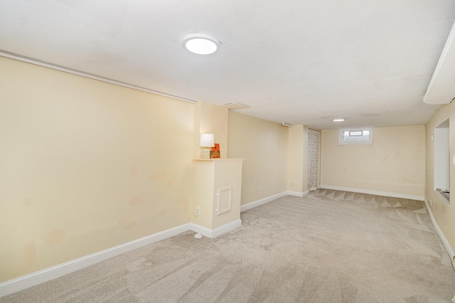 below grade area with carpet and baseboards