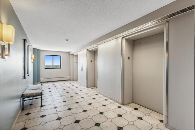 hall with elevator, baseboard heating, a textured ceiling, and light floors