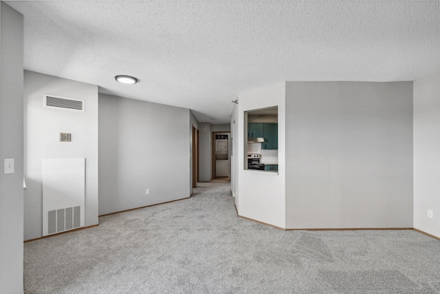 empty room featuring carpet floors, visible vents, and baseboards