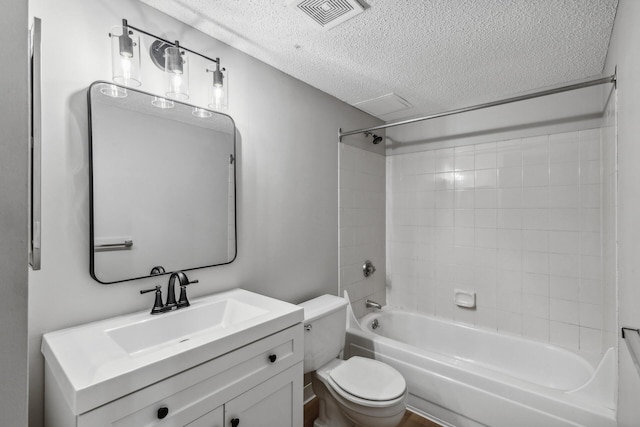 full bathroom with shower / bath combination, visible vents, toilet, a textured ceiling, and vanity