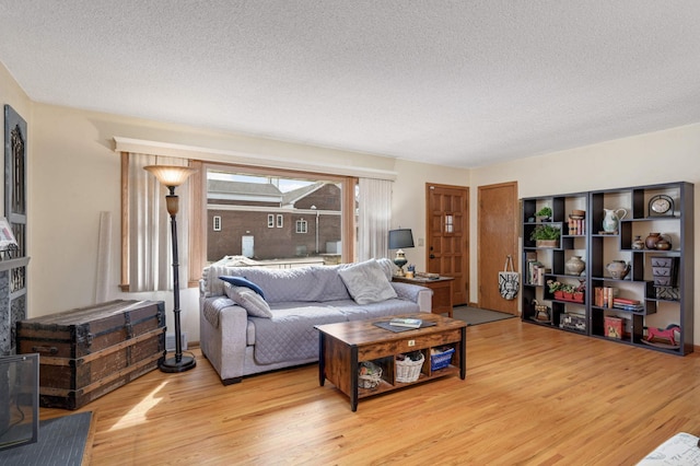 living room featuring light wood-style floors and a textured ceiling