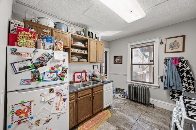 kitchen featuring a sink, open shelves, a textured ceiling, white appliances, and radiator