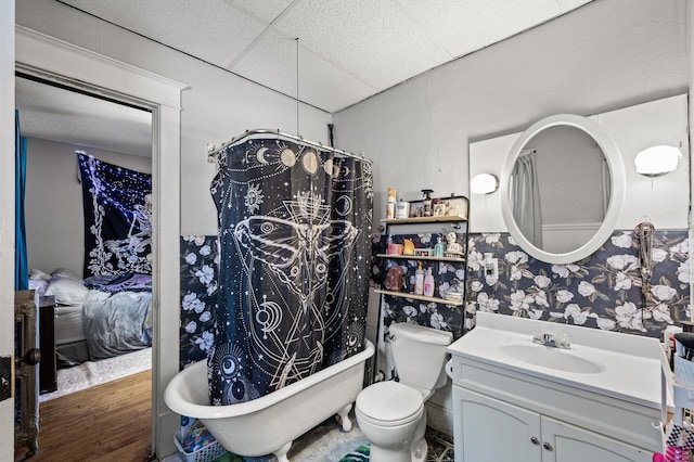 full bath with vanity, a paneled ceiling, curtained shower, toilet, and a washtub