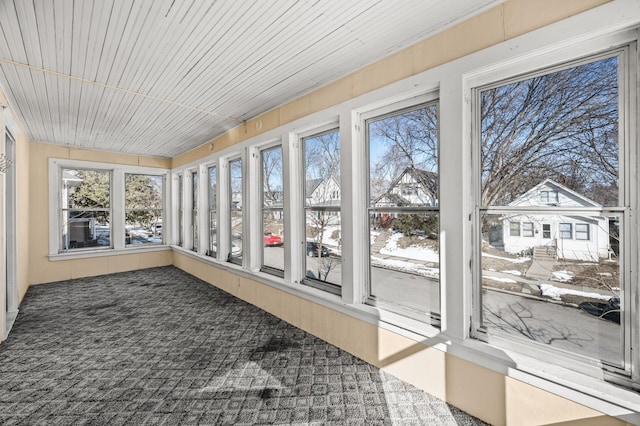 unfurnished sunroom with wood ceiling