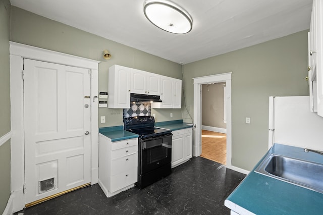 kitchen featuring freestanding refrigerator, a sink, under cabinet range hood, white cabinetry, and black electric range oven