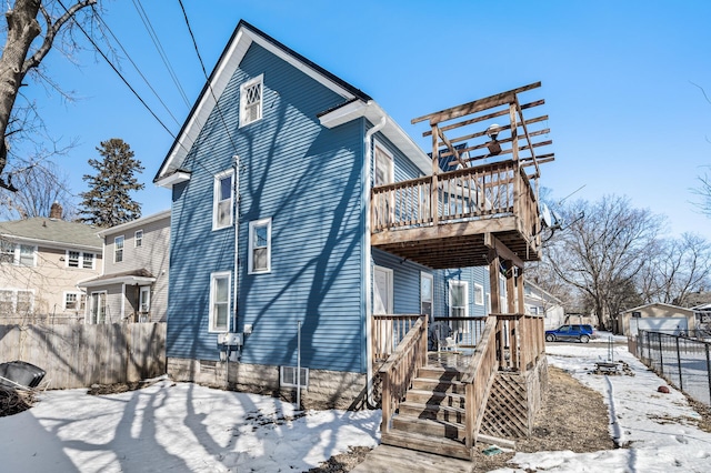 back of house with a deck, stairs, and fence