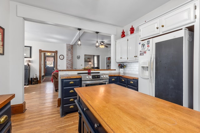 kitchen featuring white cabinets, stainless steel range with electric stovetop, blue cabinets, and white fridge with ice dispenser