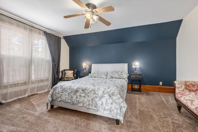 carpeted bedroom with vaulted ceiling, a ceiling fan, and baseboards