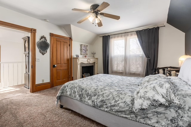 carpeted bedroom with a ceiling fan and vaulted ceiling