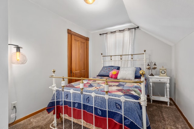 carpeted bedroom featuring baseboards and vaulted ceiling