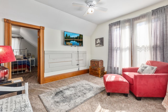 sitting room with lofted ceiling, carpet floors, and ceiling fan