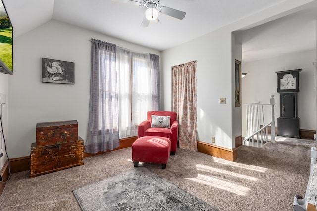 sitting room with vaulted ceiling, an upstairs landing, baseboards, and carpet floors