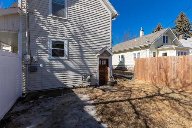 view of side of property featuring fence