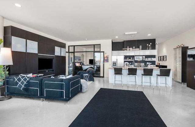 living room with recessed lighting and finished concrete flooring