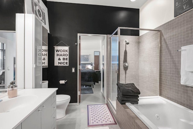 bathroom featuring toilet, vanity, a tub with jets, a stall shower, and ensuite bath