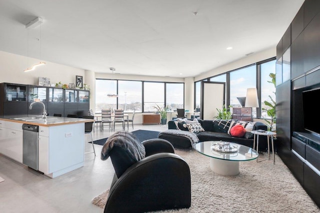 living room featuring expansive windows, concrete floors, and a wealth of natural light