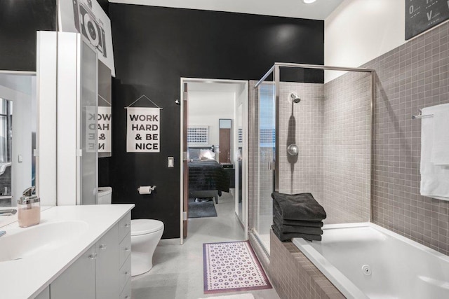 bathroom featuring vanity, ensuite bath, toilet, a whirlpool tub, and a shower stall