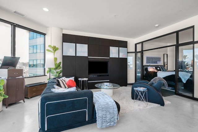 living area with visible vents and finished concrete flooring