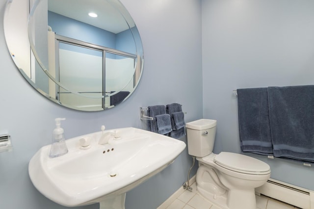 5430 Three Points Blvd Unit 131, Mound, MN 55364 - bathroom with a baseboard radiator, a sink, toilet, tile patterned flooring, and baseboards