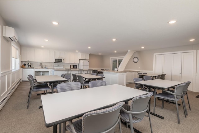 5430 Three Points Blvd Unit 131, Mound, MN 55364 - carpeted dining room with recessed lighting, a wall mounted air conditioner, a baseboard heating unit, and a sink