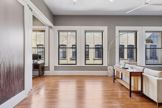 interior space with baseboards and wood finished floors