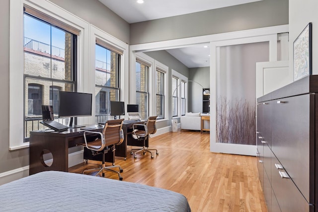 bedroom featuring recessed lighting, multiple windows, baseboards, and light wood-style floors