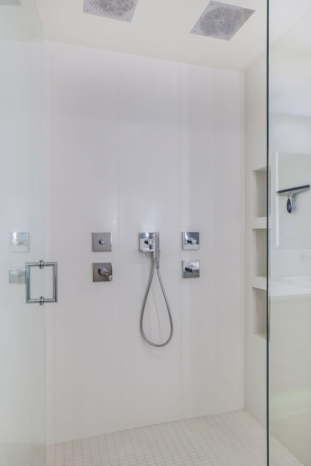 bathroom featuring visible vents and a walk in shower