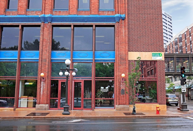 doorway to property featuring brick siding