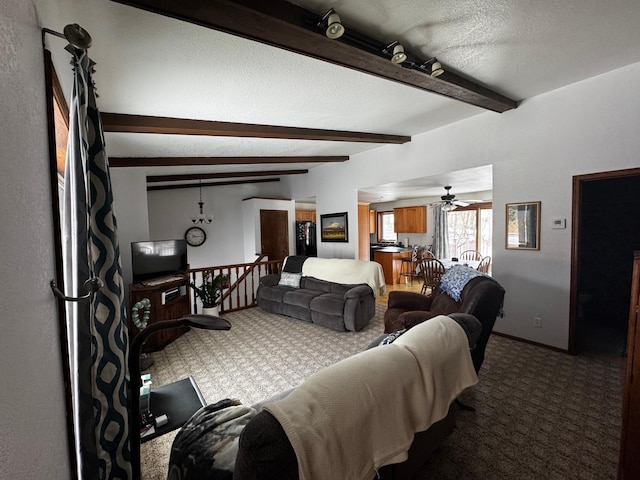 carpeted bedroom with a textured ceiling, beamed ceiling, and baseboards