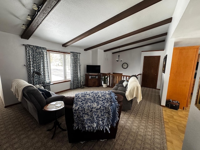 living room with lofted ceiling with beams, baseboards, and a textured ceiling