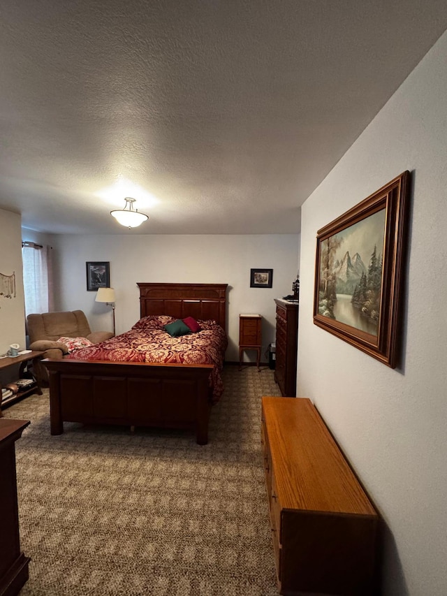 bedroom featuring a textured ceiling and carpet floors