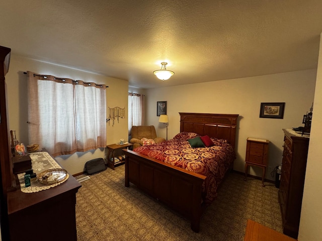 bedroom with carpet and a textured ceiling