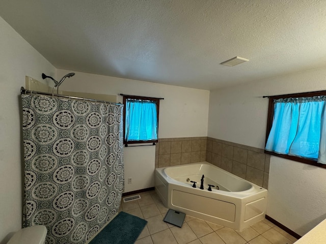 full bath with a garden tub, a textured ceiling, tile patterned flooring, and visible vents