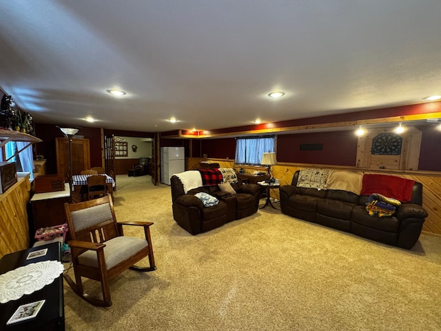 living room featuring recessed lighting, light carpet, and wooden walls