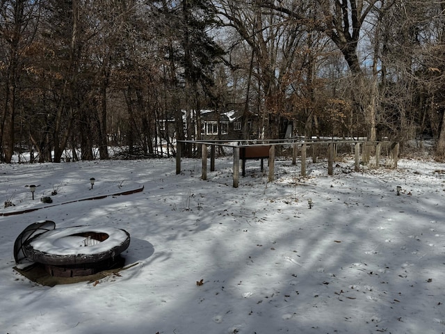 snowy yard featuring a fire pit