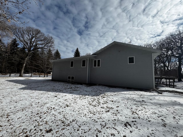 view of snow covered back of property