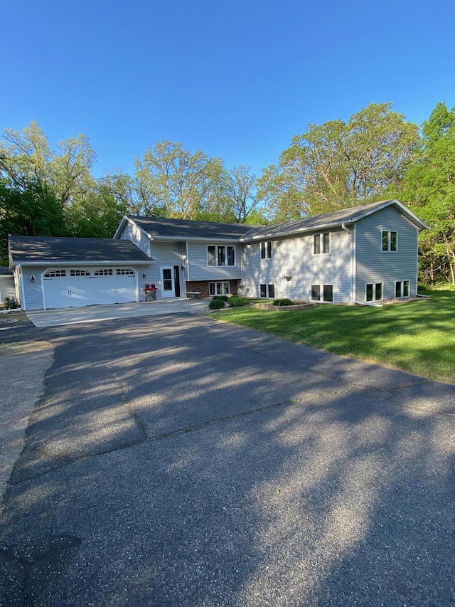 8673 Decathelon Dr, Spicer, MN 56288 - raised ranch with a garage, asphalt driveway, and a front yard
