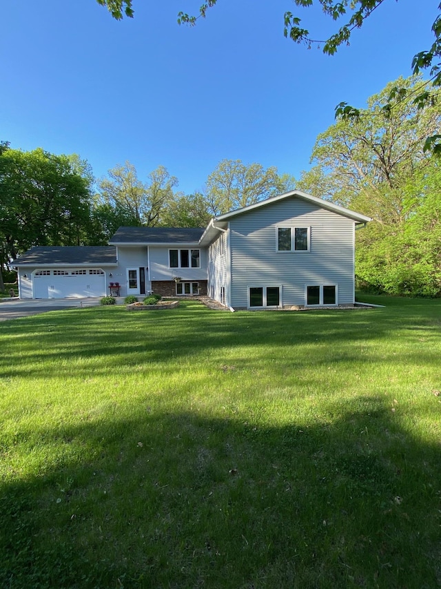 8673 Decathelon Dr, Spicer, MN 56288 - back of property featuring an attached garage and a yard