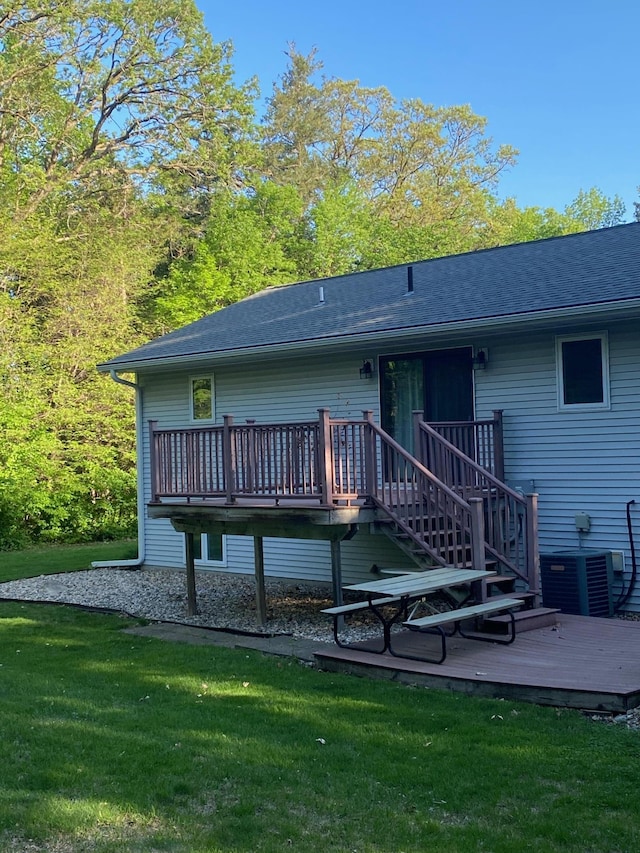 8673 Decathelon Dr, Spicer, MN 56288 - back of house featuring a deck, a lawn, and central AC unit