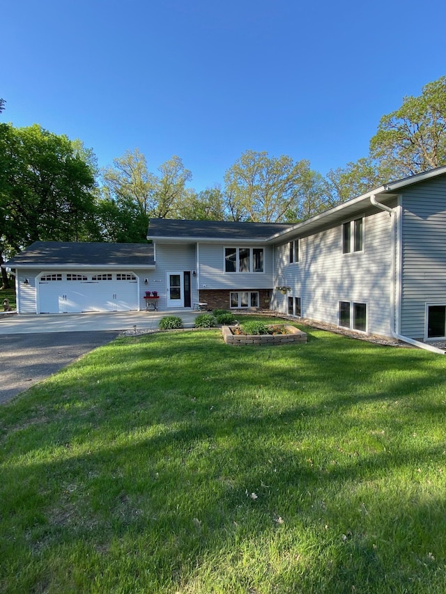 8673 Decathelon Dr, Spicer, MN 56288 - bi-level home featuring an attached garage, a front lawn, and driveway