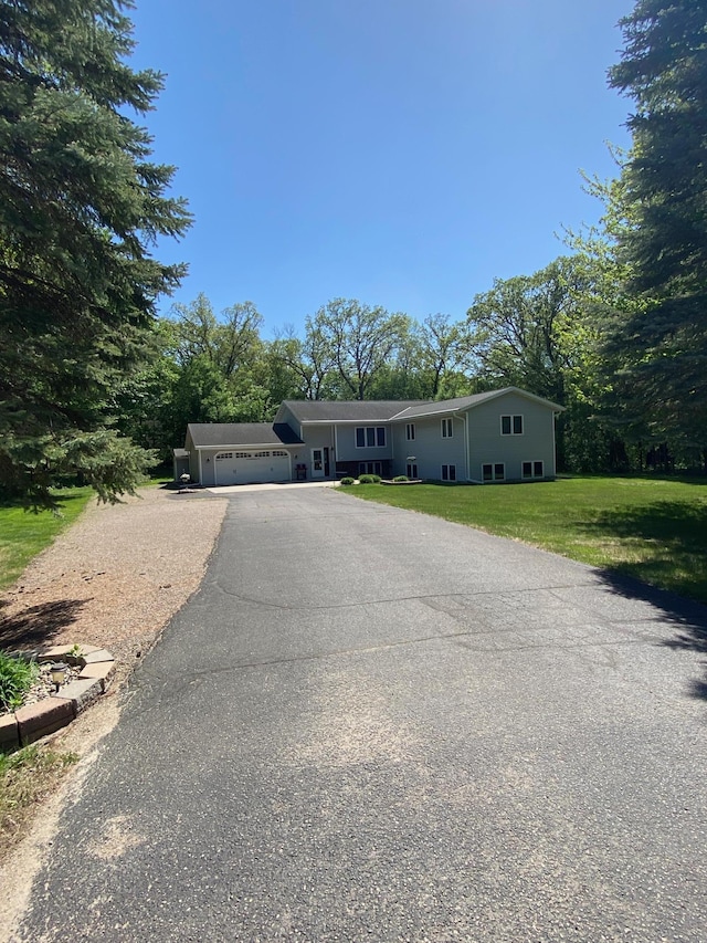 8673 Decathelon Dr, Spicer, MN 56288 - ranch-style home with driveway, a garage, and a front yard