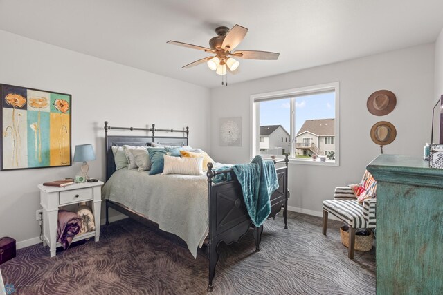 carpeted bedroom featuring ceiling fan and baseboards