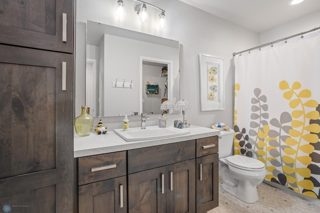 bathroom featuring a shower with shower curtain, vanity, and toilet