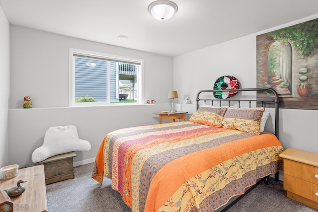 bedroom featuring carpet and baseboards